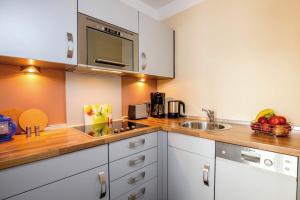 a kitchen with a sink and a counter top at ancora Marina Haus 1 Nr 06, Typ 2 in Neustadt in Holstein