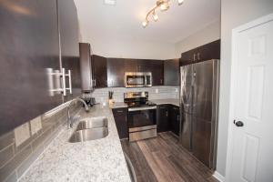 a kitchen with stainless steel appliances and wooden cabinets at Campbellton rd APT A in Atlanta