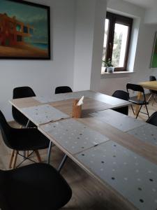 a large wooden table in a room with chairs at Noclegi na Spokojnej in Miedziana Góra