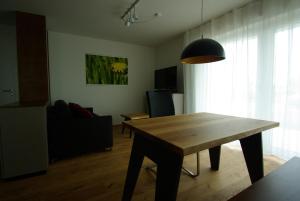 a living room with a wooden table and a dining room at Eschbach in Bettnau