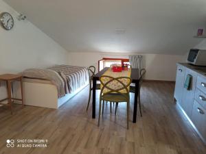 a small room with a table and a bed at B&B I GEMELLI in Sorbolo