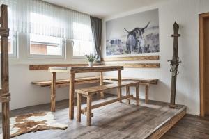 une salle à manger avec une table et des bancs dans l'établissement Fewo Helm, à Elsoft