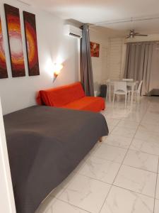 a bedroom with a bed and a dining room at ANSE DES ROCHERS St François CORAIL 306 in Saint-François