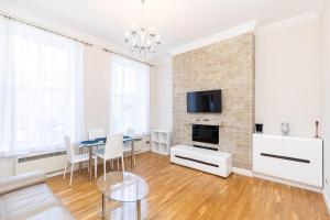 a living room with a dining table and a brick wall at Holiday Beach Flat in Bournemouth, England, UK in Bournemouth