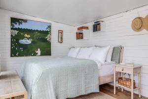 a bedroom with a bed and a painting on the wall at 4 Bedroom Archipelago Retreat in Tranholmen