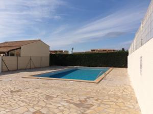 a swimming pool in the backyard of a house at horizon sur mer 1137 in Saint Pierre La Mer