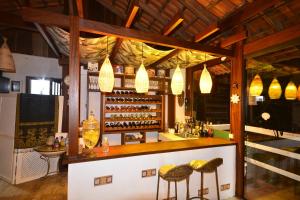a bar with two stools in front of a counter at Villa dos Ganchos in Governador Celso Ramos
