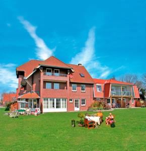 a large brick house on a green lawn at "Landhaus Voss" Typ 2 Nr8 in Staberdorf