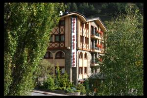 a building with a sign on the side of it at Hotel Xalet Verdú in Arinsal