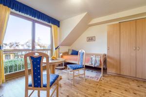 a bedroom with a bed and a table and chairs at Sommerwind Whg 3 in Zingst