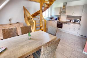 a kitchen with a wooden table with a bottle on it at Wittek, Birgit-Christin, Whg 8 in Zingst