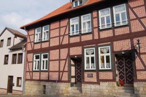 a brown and white building with white windows at Ferienwohnung am neuen Thore III in Blankenburg
