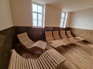 uma fila de cadeiras num quarto com janelas em Penzión SESSLER *** em Trnava