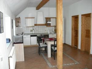 a kitchen with a table and chairs in it at Alte Pastorei Arle in Arle