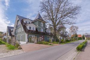 a large house on the side of a street at Les Belles, Haus Bastien, FW Charmant, Whg 7 in Zingst