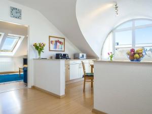 a kitchen with a counter with a bowl of fruit on it at Likedeeler Weg 1 Whg 23 in Zingst