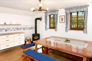 a kitchen with a wooden table and a stove at Vinný sklípek Blatnice in Blatnice
