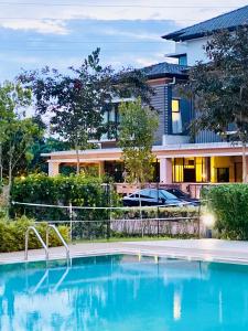 a large swimming pool in front of a building at Faizal Madhi Homestay in Kuching