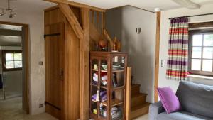 a living room with a book shelf and a couch at La duvallerie chambre d hôte in Cangey