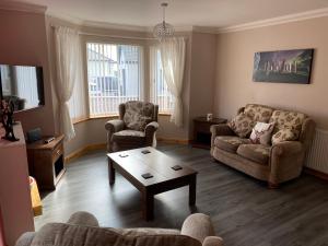 a living room with two couches and a coffee table at Tigh Murdag, 37D Newmarket HS2 0DT in Stornoway