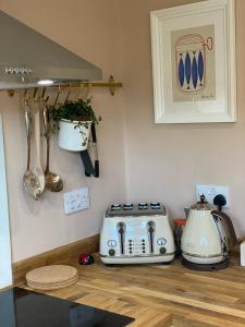 a kitchen counter with a toaster and a toaster and utensils at Relaxing holiday cottage in the beautiful Usk Valley in Usk