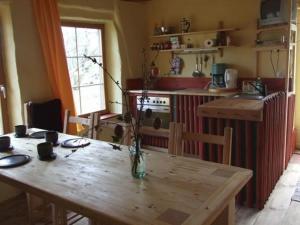 eine Küche mit einem Holztisch, einem Tisch und einem sidx sidx in der Unterkunft Scheune in Kirch Mulsow