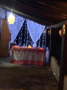 a room with a table with lights on it at Casa de praia para sonhar in Luis Correia