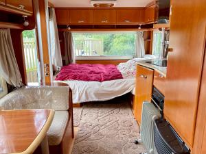 A bed or beds in a room at Inviting 5 Beth Caravan in Corwen North Wales