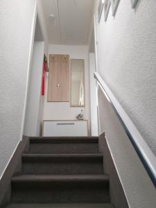 a hallway with a staircase leading to a bathroom at Ferienwohnung Familie Ruff in Großenbrode