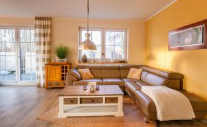 a living room with a couch and a table at Seeadler - a26427 in Zingst