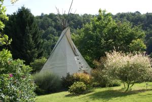 a white tent sitting in the middle of a garden at Le Refuge du Clos du Moulin in Brionne +20 photos