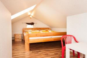 a bedroom with a wooden bed in a attic at Wohnung 2 in Fehmarn