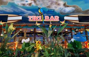 a bird sitting on a sign at a tiki bar at Margaritaville Resort Times Square in New York