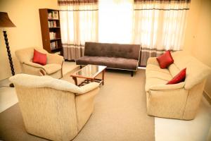a living room with two chairs and a couch at Freedom Lodge, Kandy in Kandy