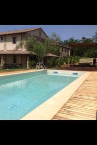 a large swimming pool in front of a house at Bosco Ai Marzi in Poggibonsi