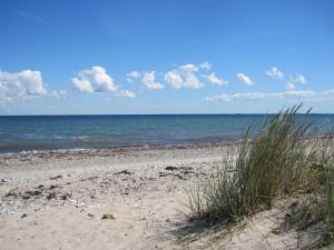a sandy beach with a view of the ocean at Fewo im Kastania Nr19 in Petersdorf auf Fehmarn