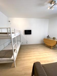 a living room with bunk beds and a tv at Residence Foemina 65 Val di Luce in Abetone