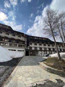 a large apartment building with snow on the ground at Residence Foemina 65 Val di Luce in Abetone