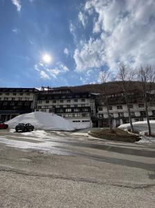 a car parked in a parking lot in front of a building at Residence Foemina 65 Val di Luce in Abetone +18 photos