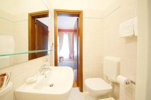 a white bathroom with a toilet and a sink at DolceVita Apartments N. 488 in Venice