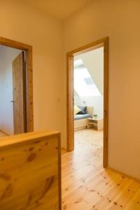 a room with an open door and a mirror at Ferienwohnung 3 in Hoyerswerda