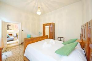 a bedroom with a large white bed with green pillows at DolceVita Apartments N. 490 in Venice