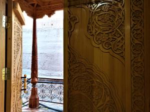 a door with a carving on a wall at Art House Boutique Hotel in Khiva