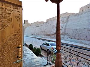 a car parked on a balcony looking out at a castle at Art House Boutique Hotel in Khiva