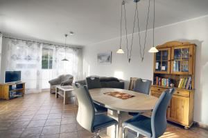 a dining room with a table and chairs at Nele, Whg 1 in Zingst