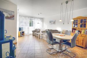 a kitchen and living room with a table and chairs at Nele, Whg 1 in Zingst