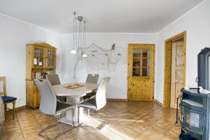 a dining room with a table and chairs and a tv at Nele, Whg 1 in Zingst