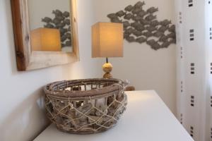 a basket with a lamp on a table at Strandhafer V4W2 in Dierhagen