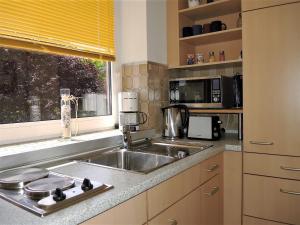 a kitchen with a sink and a window at Fewo 91 WHG B 18 in Burhave in Burhave