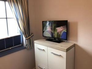 a flat screen tv sitting on top of a dresser at Villa "Meereslust", Whg 3 in Zingst